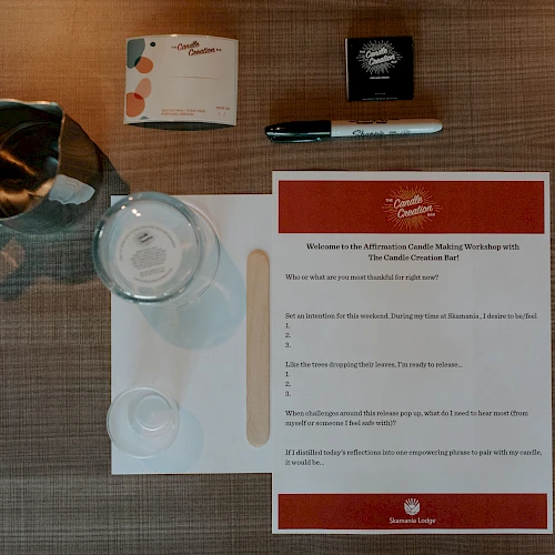 A setup with a pitcher, glass, notepad, pen, and paper containing text, organized neatly on a table.